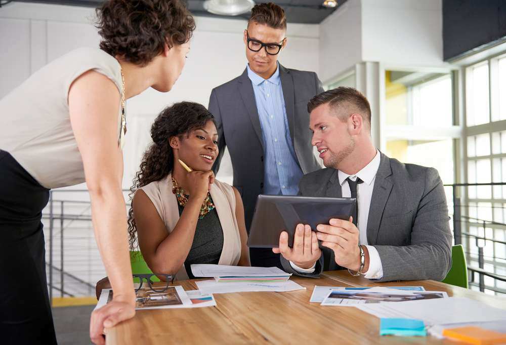 team of successful business people having a meeting in executive sunlit office-1